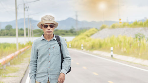 Portrait of man standing on road