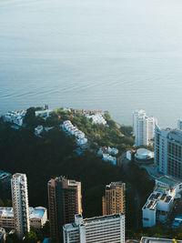 High angle view of cityscape by sea against sky