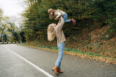 Rear view of woman walking on road