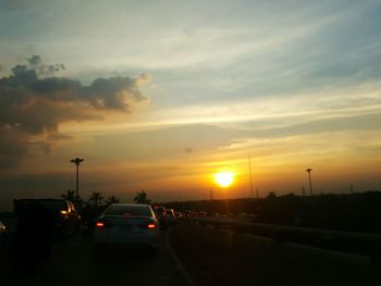 Traffic on highway at sunset