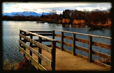 Pier over lake against sky