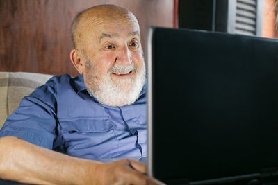 Man using mobile phone while sitting on table