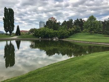 Scenic view of lake by trees against sky