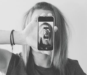 Portrait of woman photographing with camera