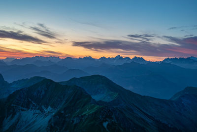 Scenic view of snowcapped mountains against sky during sunset