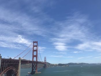 Low angle view of golden gate bridge against blue  cloudy sky in san francisco