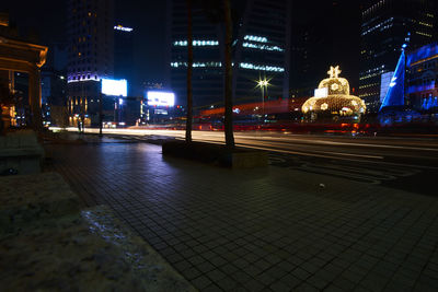 Statue of illuminated city at night
