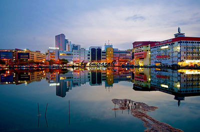 Reflection of illuminated buildings in lake