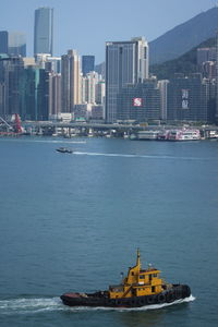 Scenic view of sea against buildings in city