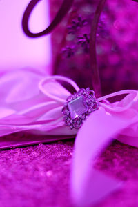 Close-up of pink rose on purple flower