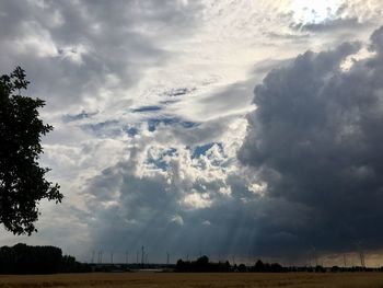 Scenic view of storm clouds over field