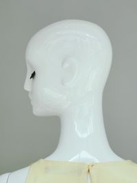 Close-up of mannequin against gray background