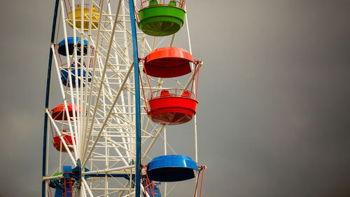 Low angle view of ferris wheel against sky