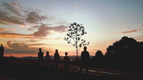 Silhouette people against sky during sunset