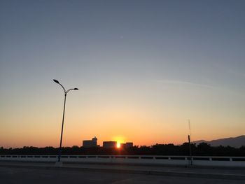 Street against clear sky during sunset