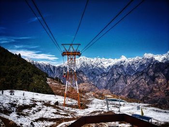 Snow covered landscape against blue sky