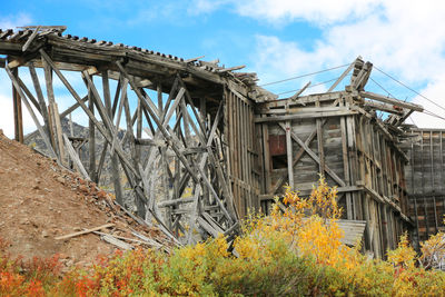 Low angle view of abandoned bridge against sky