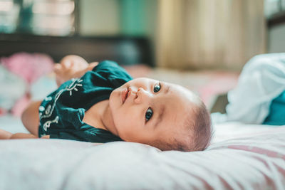 Young boy sleeping on bed at home