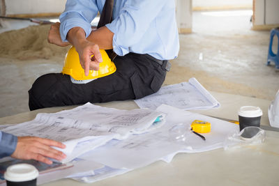 Male architects discussing at desk in office