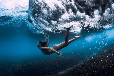 Young woman swimming in sea