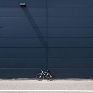 Bicycle wheel against wall in city