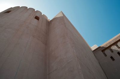 Low angle view of building against clear blue sky