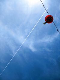 Low angle view of vapor trails against blue sky