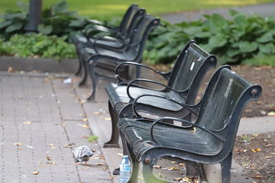 Close-up of empty bench in park