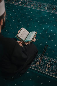 High angle view of man reading book