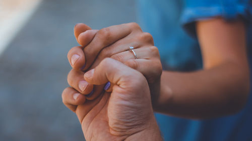 Close-up of couple holding hands