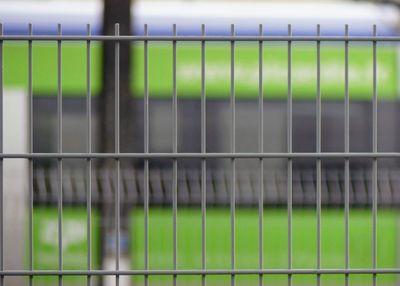 Close-up of metal fence on field