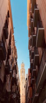 Low angle view of buildings against clear blue sky