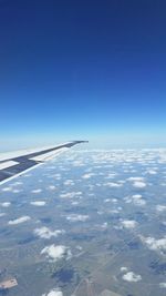Cropped image of airplane flying over landscape
