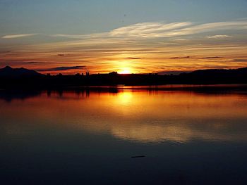 Scenic view of lake at sunset
