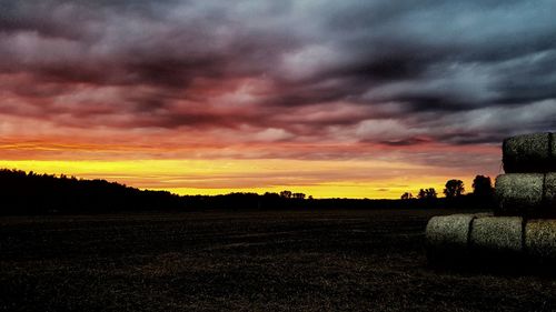 Scenic view of field against sky during sunset