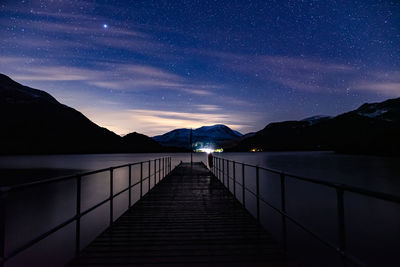 Scenic view of lake against sky at night