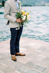 Midsection of woman holding bouquet