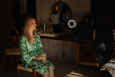 Woman sitting on table at home