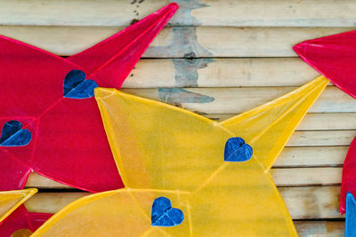 High angle view of multi colored flags on wooden wall