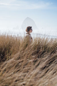 Profile view of woman on grassy beach