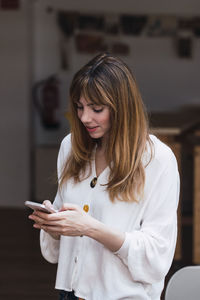 Businesswoman using mobile phone in office