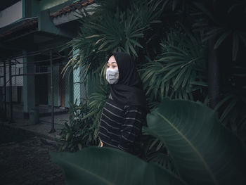 Portrait of man standing against plants