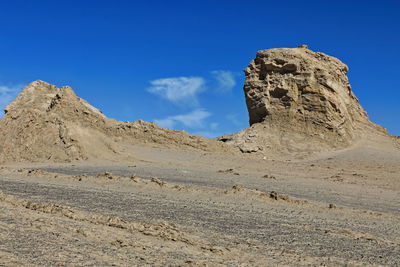 Low angle view of rock formations against sky