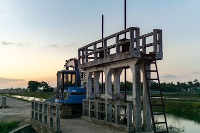 Built structure on pier against sky during sunset