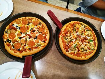 High angle view of pizza served on table