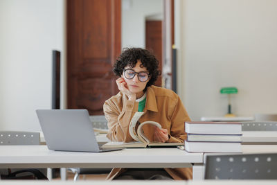 Young woman using laptop at office