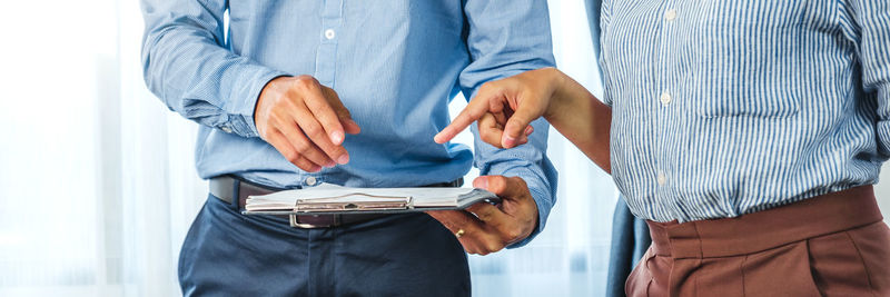 Midsection of man holding bag