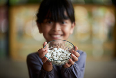 Close-up of boy eating food at home