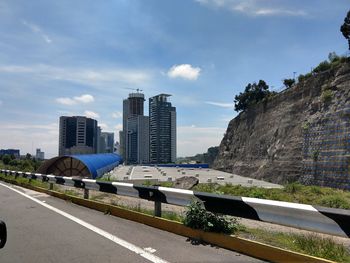 View of city buildings against cloudy sky