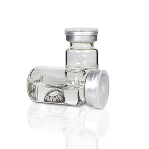Close-up of glass bottle against white background
